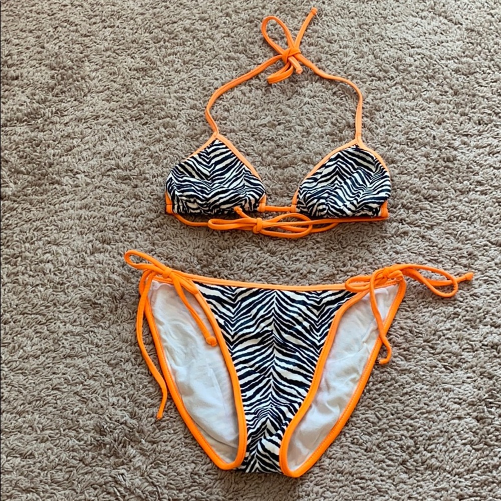 Zebra print bathing suit with neon orange outline.